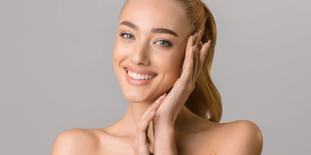 Dermal Fillers Are a Medical Treatment: How to Choose a Qualified Injector in Bend, OR 1 beautiful smiling woman touching her face